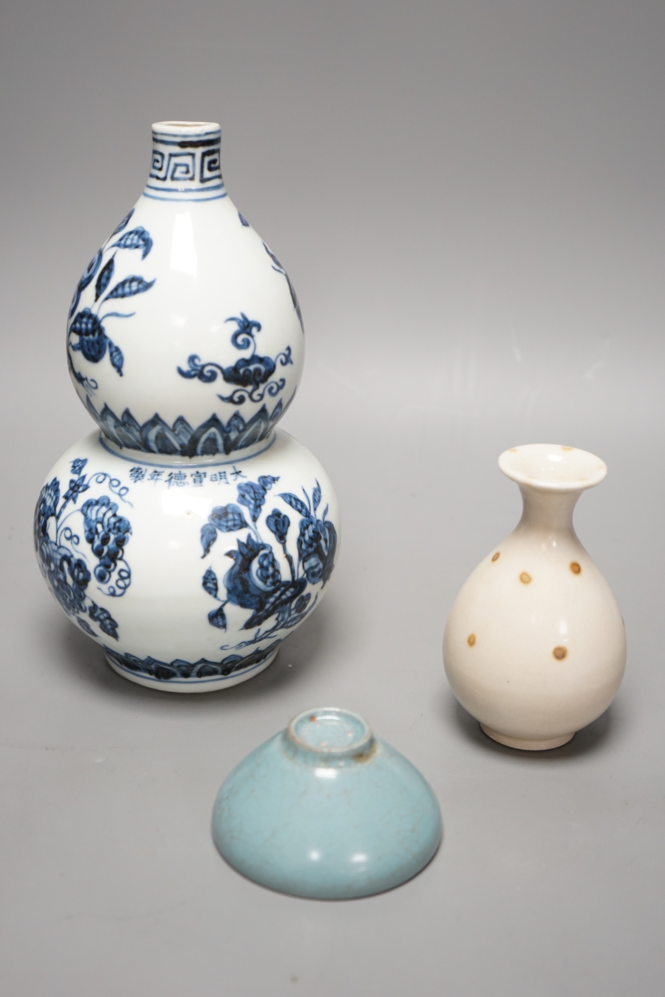 A Chinese blue and white double gourd vase, a Jun-type cup and a small baluster vase